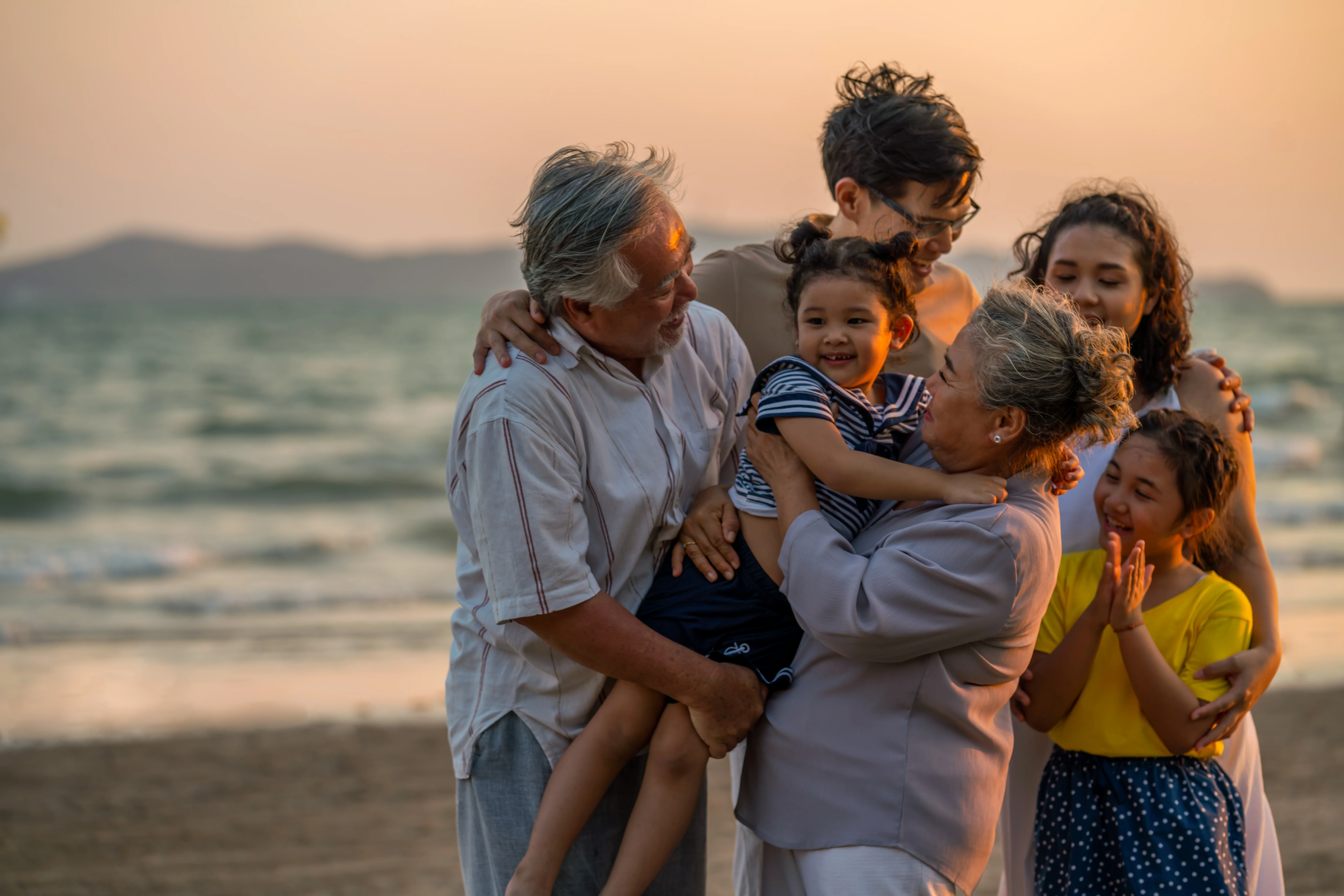 a family posing on a beach