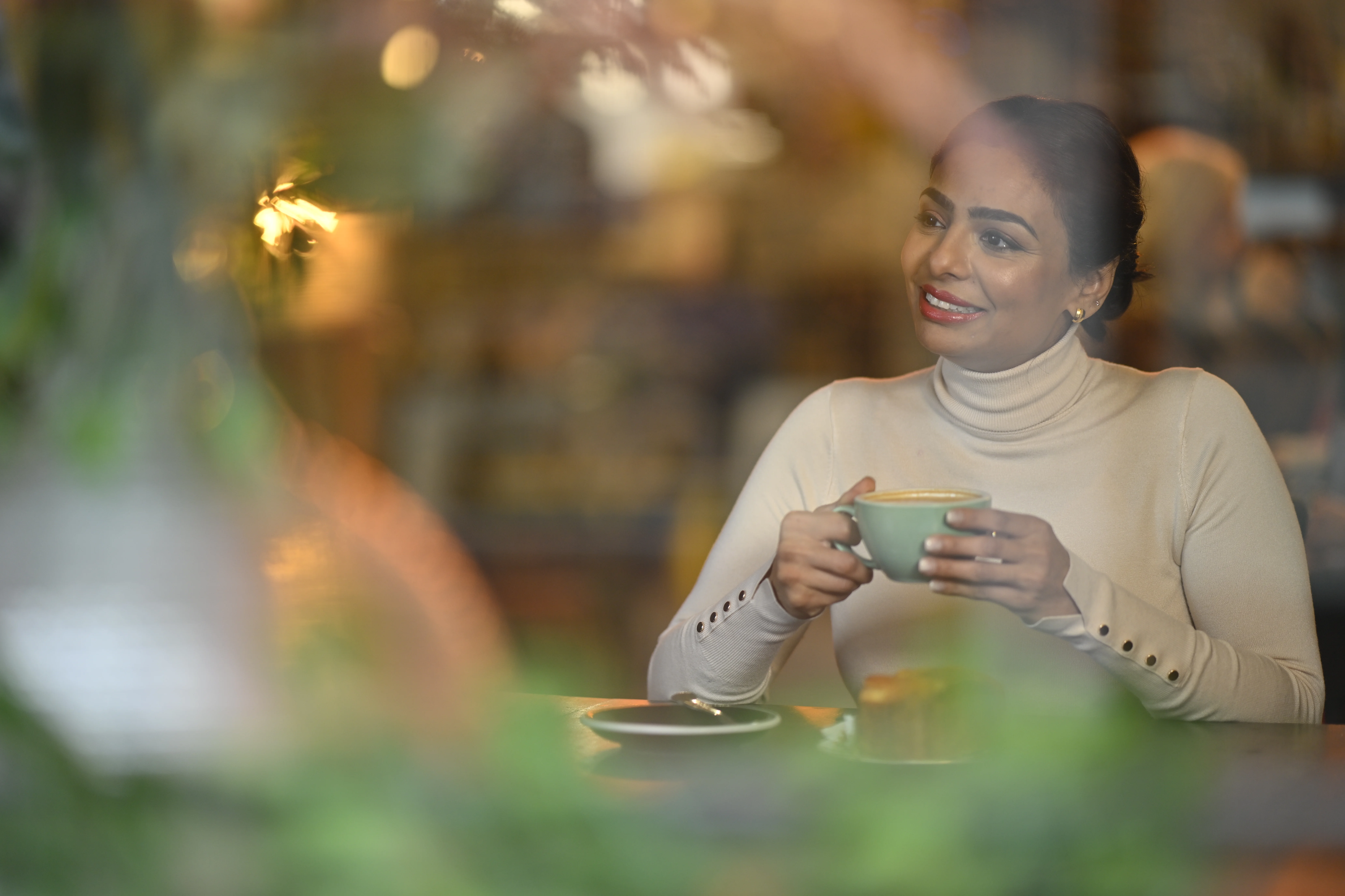 Woman sitting sipping coffee