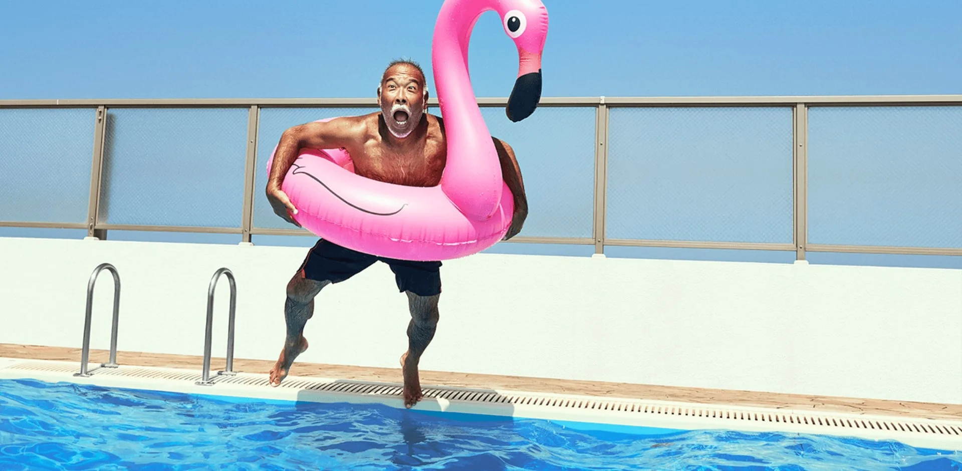a man jumping into a pool